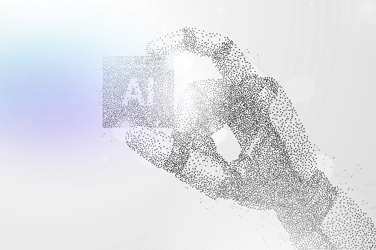 robot hand holding an tile that says AI on it